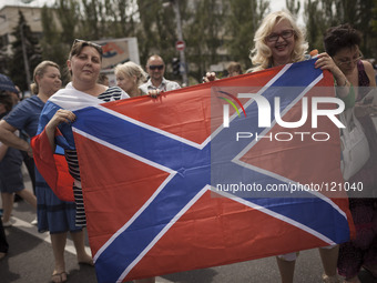 Holding the flag of Novorossiya, the new state formed after the union of the pro-Russian, separatist entities of Donetsk and Lugansk, after...