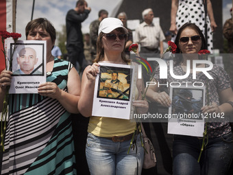 Pro-Russian women holding photos of recent victims of the fighting in Eastern Ukraine at a rally held in Lenin's square, Donetsk, against Uk...
