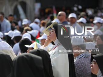 People attend a mass given by Pope Francis at Manger Square outside the Church of Nativity in the West Bank city of Bethlehem, May 25, 2014....