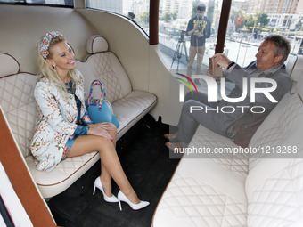 People take pictures inside the prototype of a new Ukrainian electric car 