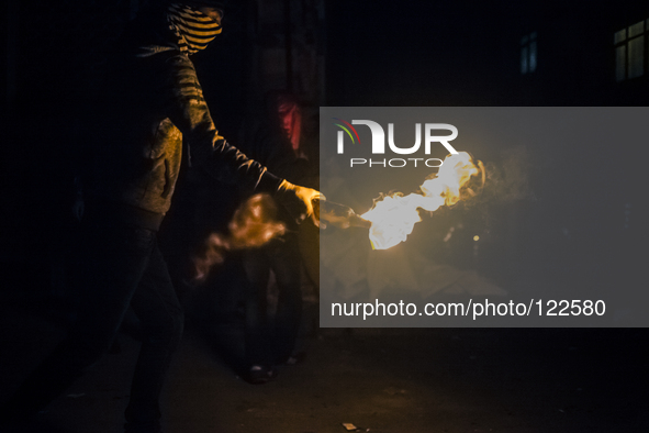 A protester with molotov cocktail during clashes with police in the Alevi enclave of Okmeydani on Istanbul on May 26, 2014. 