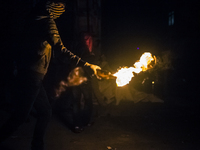 A protester with molotov cocktail during clashes with police in the Alevi enclave of Okmeydani on Istanbul on May 26, 2014. (