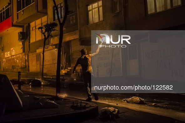 A protester with molotov cocktail during clashes with police in the Alevi enclave of Okmeydani on Istanbul on May 26, 2014. 
