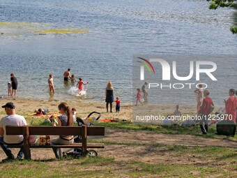 People enjoy sunny and warm spring weather sunbathing and swimming in Otominskie lake in Kashubia region, Poland. Meteorologists predict tem...