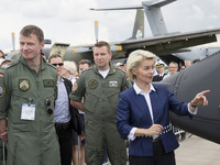 German Defense Minister Ursula von der Leyen (C) chats with a members of the Luftwaffe, the German air force, during a visit at the ILA 2016...