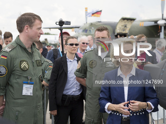 German Defense Minister Ursula von der Leyen (C) chats with members of the Luftwaffe, the German air force, during a visit at the ILA 2016 B...