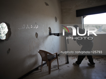 A Free Syrian Army fighter fires his heavy weapon during clashes with forces loyal to Syria's President Bashar al-Assad in the Khan al-Assal...