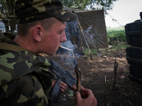 Ukrainian paratrooper smokes the cigaret while having rest after long patrol in Donetsk region (
