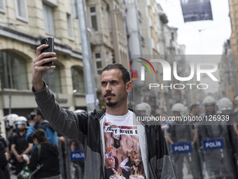 CAPTION CORRECT - A man takes a self portrait near one of numerous police lines set up throughout central Istanbul on May 31, 2014. Scores o...