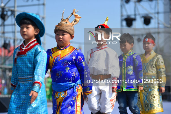 Children present costumes at Sino-Russian-Mongolian Costume Festival in Hulunbuir, north China's Inner Mongolia Autonomous Region, June 24,...