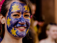 A woman with her face painted as a European flag is pictured as thousands of protesters take part in a March for Europe, through the centre...