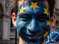 A man with his face painted as a European flag is pictured as thousands of protesters take part in a March for Europe, through the centre of...