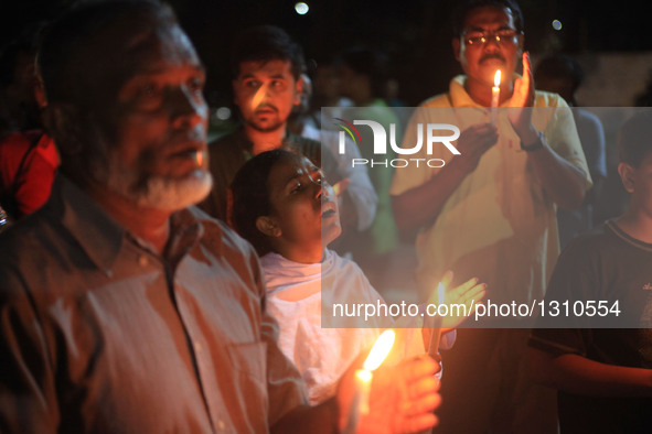 Bangladeshi social activists hold candles in memory of victims killed in an attack in Dhaka's diplomatic enclave Gulshan, Bangladesh, July 3...