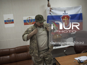 The commander of the Russian Orthodox Army seen inside his office in the unit's headquarters in the occupied SBU building in Donetsk, easter...