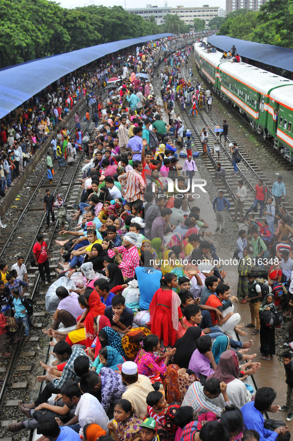 Passengers travel on top of a train leaving for their hometowns for the upcoming Eid al-Fitr festival in Dhaka, Bangladesh, July 5, 2016.