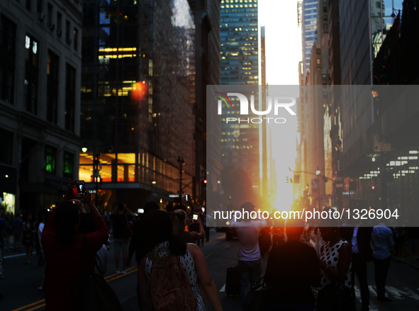 People take photos of Manhattanhenge in Manhattan, New York, the United States, on July 11, 2016.