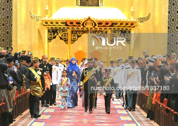Brunei's Sultan Haji Hassanal Bolkiah (C) and the royal family attend a ceremony to confer state decorations on 22 people at Istana Nurul Im...