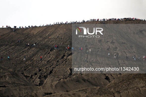 People hike to watch offerings thrown in Mount Bromo during the traditional Kasada festival in Probolinggo, East Java, Indonesia, July 21, 2...
