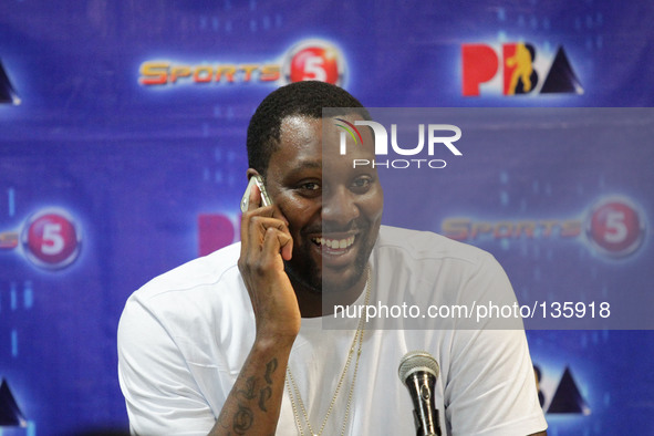 Quezon City, Philippines - NBA veteran Andray Blatche answers a phone call during a press conference in Quezon City on June 9, 2014. The NBA...