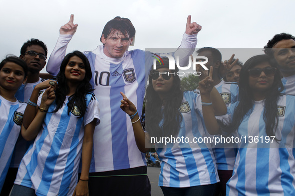 Fans of Argentina football team Lionel Messi's poster in Dhaka.
The World Cup is upon us again, bringing with it, its all-conquering game sp...