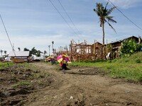 Tacloban, Philippines - A girl walks with an umbrella on her way to school in Tacloban City on June 11, 2014. On November 8, 2013, Haiyan, o...