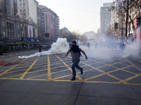 Protesters fleeing tear gas fired by riot police.


Chilean students, convened by the Confederation of Chilean Students, known as CONFECH...