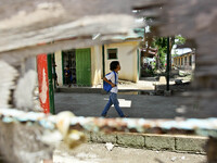 Tacloban, Philippines - A student is seen walking past a damaged window in San Jose Central School, Tacloban City on June 11, 2014. On Novem...