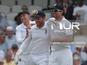 England's Jonny Bairstow celebrates his catch with England's Alastair Cook during Day Three of the Fourth Investec Test Match between Englan...