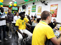 People watch the World Cup game between Brazil and Croatia in a bar on the east side of São Paulo, Brazil on June 12, 2014. (