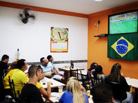 People watch the World Cup game between Brazil and Croatia in a bar on the east side of São Paulo, Brazil on June 12, 2014. (