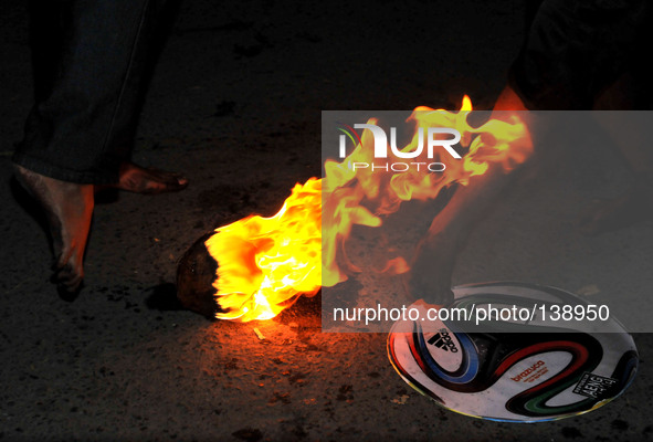 SOLO, CENTRAL JAVA, INDONESIA - JUNE 12 : Indonesian men playing football fire 
