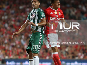 Benfica's forward Franco Cervi  heads the ball with Setubal's forward Ze Manuel during the Portuguese League football match SL Benfica vs Vi...