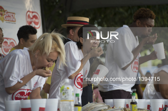 Matt Stonie (2-R) competes in the Gyoza Eating Championship in Los Angeles, the United States, Aug. 20, 2016. Matt Stonie finished 323 gyoza...