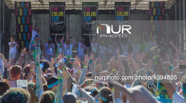 People gather at a stage after crossing the finishing line of the Color Run in Sydney, Australia, on Aug. 21, 2016. The Color Run, known as...