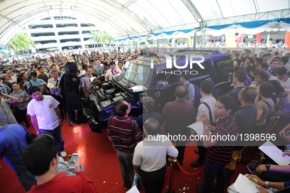 People attend an auction of seized luxury cars at the Thai Customs headquarters in Bangkok Aug. 23, 2016. A total of 343 seized luxury cars...