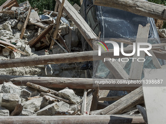 A car under a destroyed building in Pescara del Tronto, Italy, on August 24, 2016. A powerful pre-dawn earthquake devastated mountain villag...