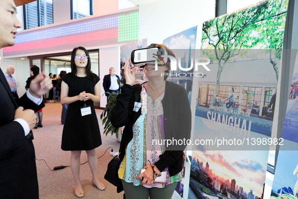 A visitor watches a VR promotional video showcasing a panoramic view of the beauty of the China's Shanghai during a tourism promotion event...