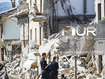 Rescuers search for victims in damaged buildings after a strong earthquake hit Amatrice on August 24, 2016. Central Italy was struck by a po...