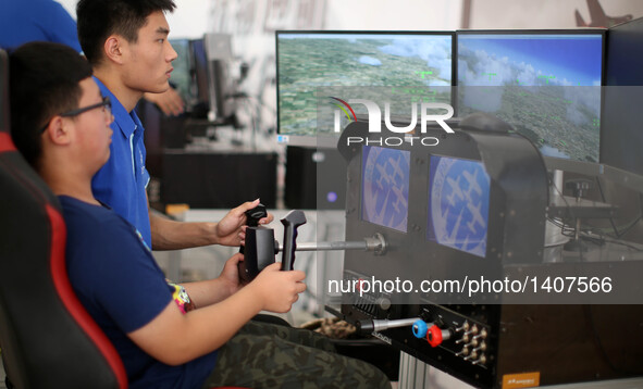 A visitor experiences a virtual reality flight simulator during the 5th Shenyang Faku International Flight Conference in Faku County of Shen...
