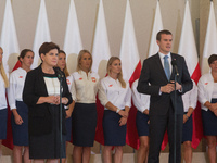 Prime Minister of Poland, Beata Szydlo (C) and Polish minister of sport and tourism, Witold Banka (R) met with Olympic medalists from Rio in...