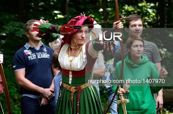 A woman dressed as an archer performs during 