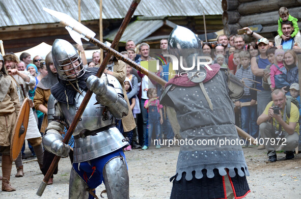 People dressed as European knights fight during 