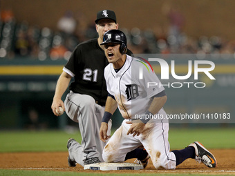 Detroit Tigers second baseman Ian Kinsler (3) reacts after sliding into third base safety  during the third inning of a baseball game agains...