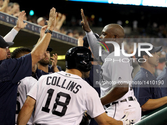 Detroit Tigers left fielder Justin Upton (8) is congratulated by teammates in the dugout after scoring a run in the sixth inning of a baseba...