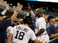 Detroit Tigers left fielder Justin Upton (8) is congratulated by teammates in the dugout after scoring a run in the sixth inning of a baseba...