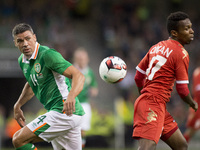 Jonathan Walters of Ireland and Ali Al-Busaidi of Oman fight for the ball during the International Friendly football match between Republic...