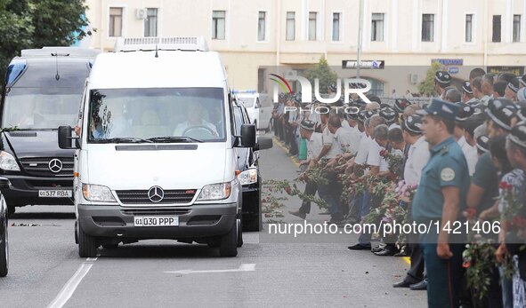 People gather along the road to watch the vehicle carrying the coffin of the late president of Uzbekistan Islam Karimov in Samarkand, Uzbeki...