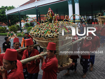 Keraton Yogyakarta servant known as ‘abdi dhalem' carrying food and offering called 'Gunungan' during the Grebeg Besar ritual in Yogyakarta,...