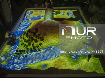 A visitor viewed a augmented reality sandbox in Gajah Mada University Expo, Yogyakarta, Indonesia, on September 20, 2016. This event showcas...