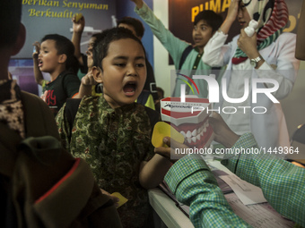 Students viewed a dentures in Gajah Mada University Expo, Yogyakarta, Indonesia, on September 20, 2016. This event showcases the work of the...